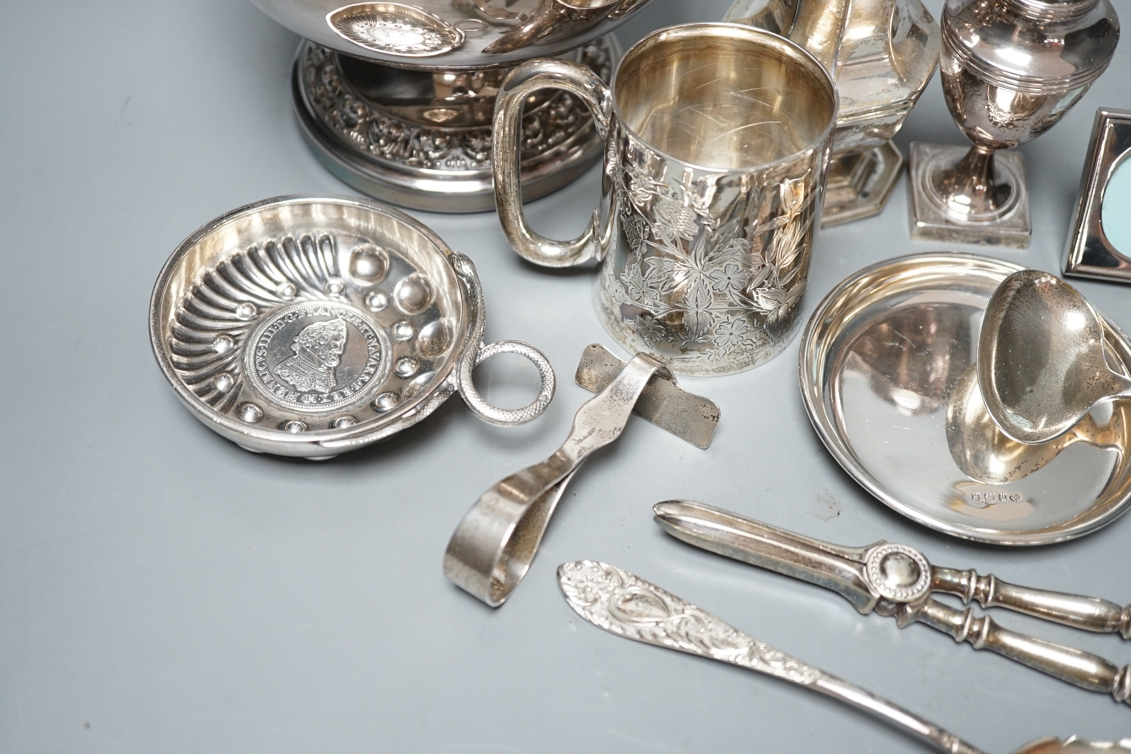A George III silver vase shaped pepperette, Richard Evans? London, 1788, 88mm, a Victorian silver christening mug, a later silver sugar caster, a French white metal taste vin and other sundry silver and plated items.